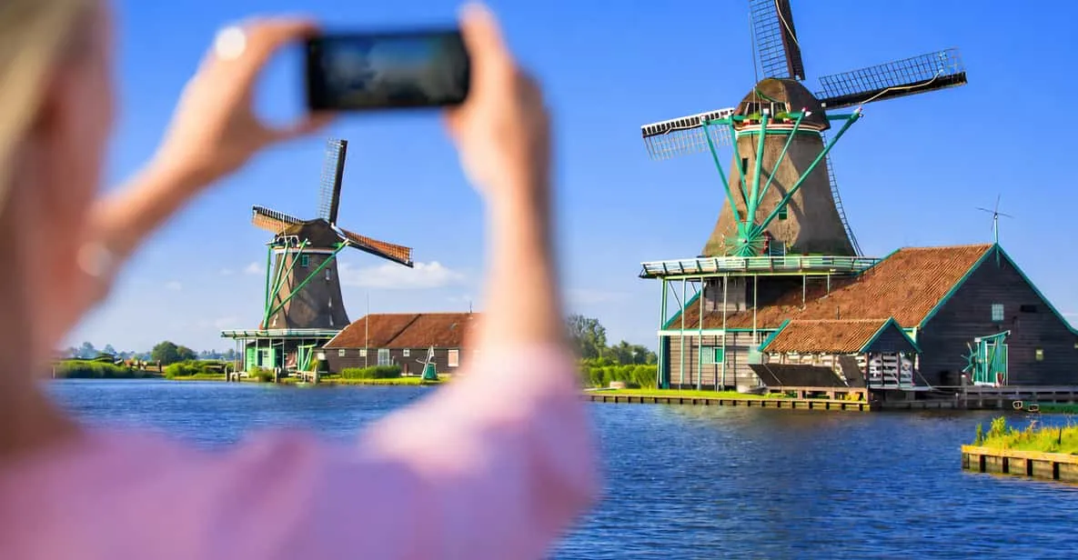Visitors walking past a wooden windmill and clog workshop on a half-day Amsterdam windmill tour to Zaanse Schans